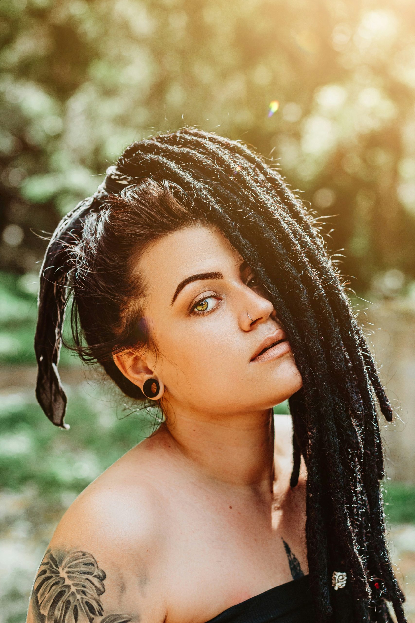 Soft Locs Hairstyle in Long Wrapped Locs with Curly Ends on Natural Black Hair
