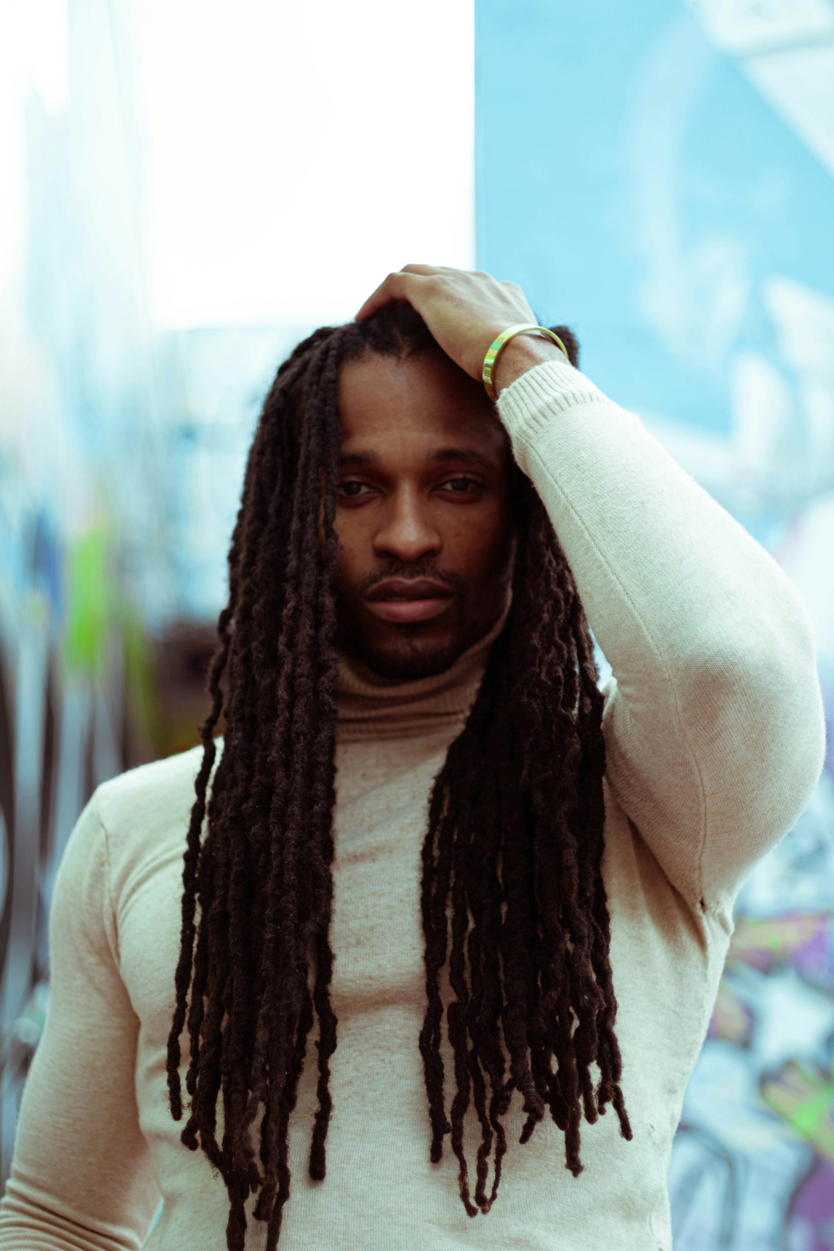 Wicks Hairstyle with Thick Cylindrical Locs Standing Up on a Dark-Haired Man