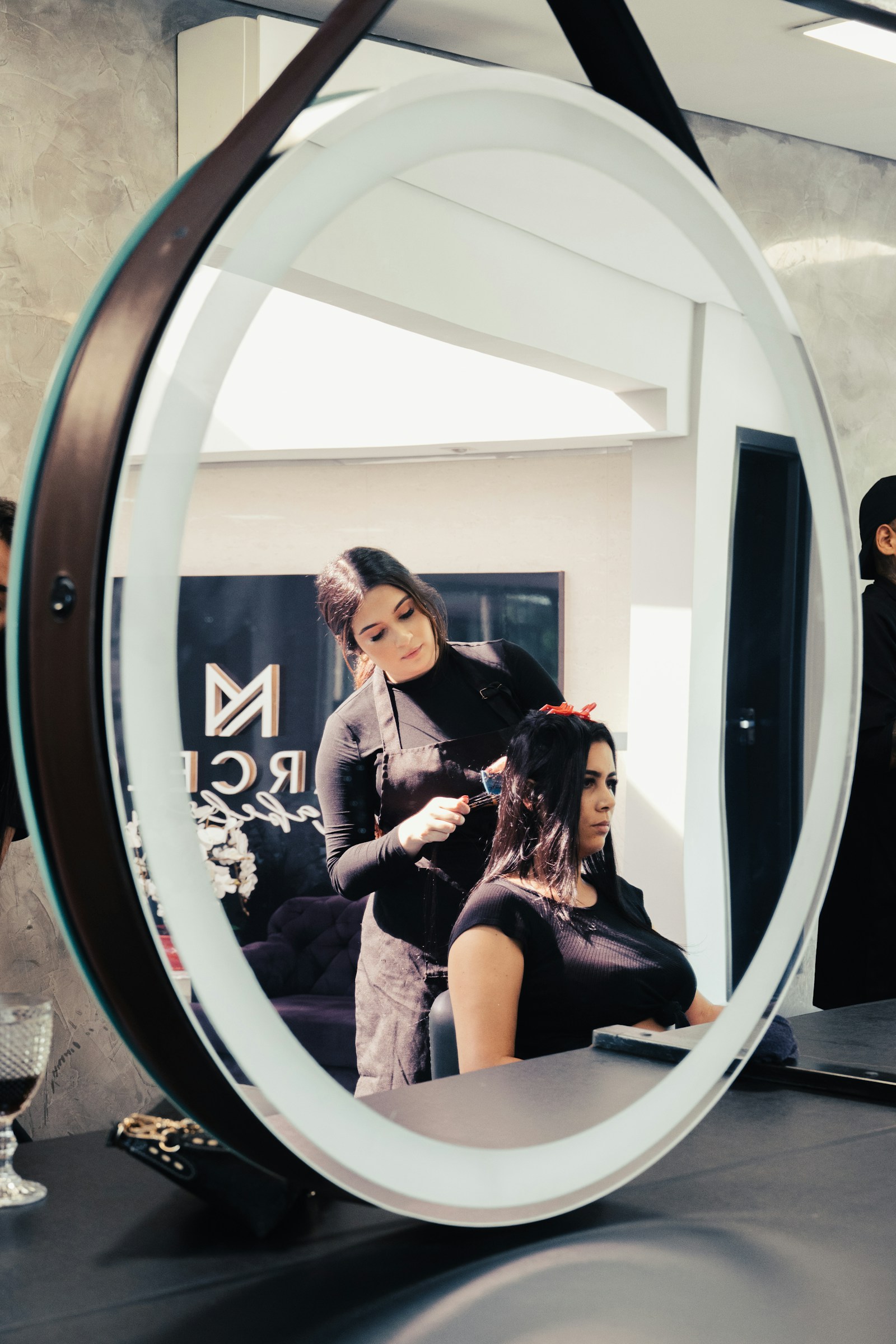 Haircut Regret Salon Mirror Consultation Woman in a Salon Chair Reviewing a New Haircut in the Mirror with Her Stylist