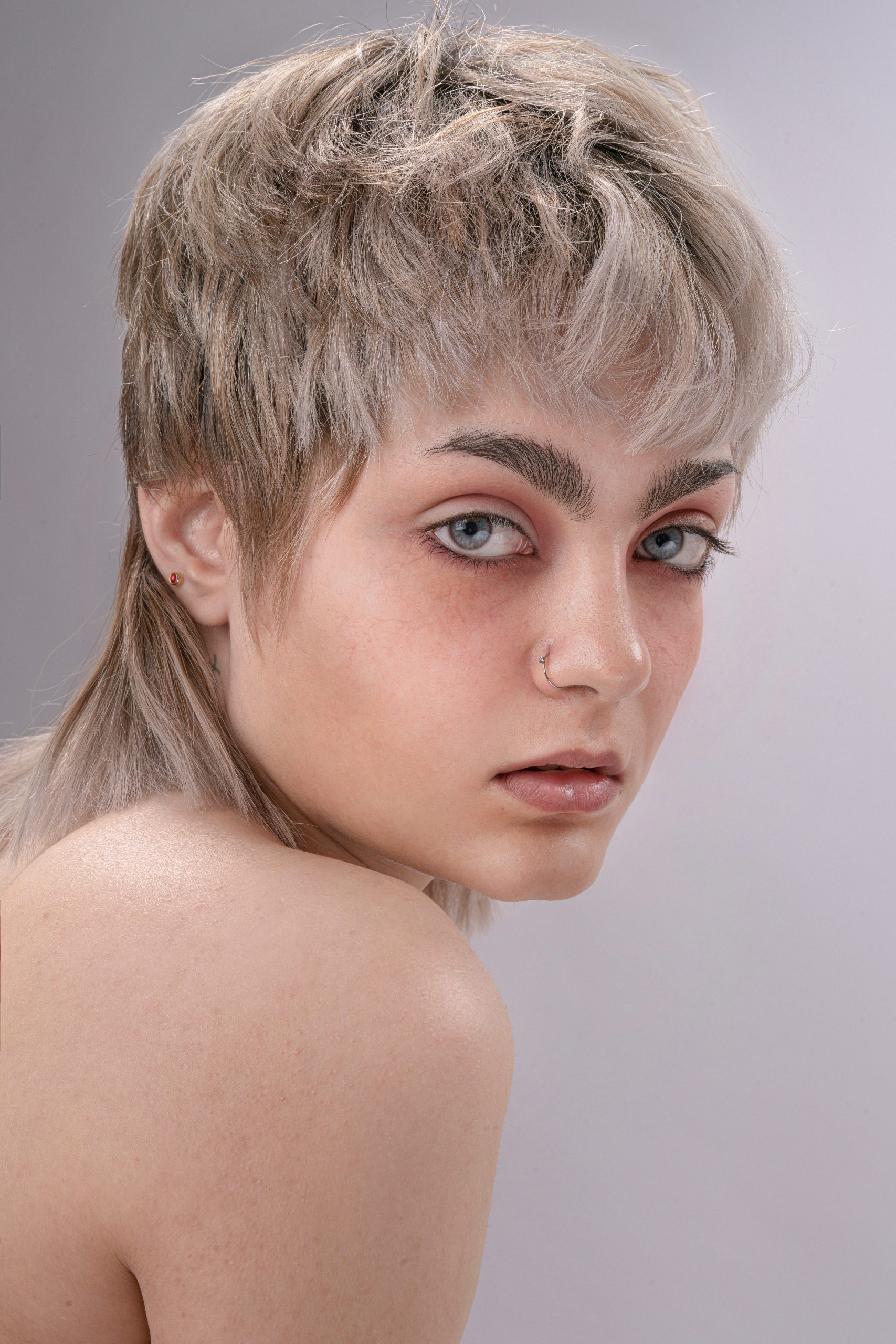 Mixie Haircut Mullet Meets Pixie Mixie Haircut with a Cropped Pixie Crown and a Longer Textured Mullet Nape on Dark Wavy Hair