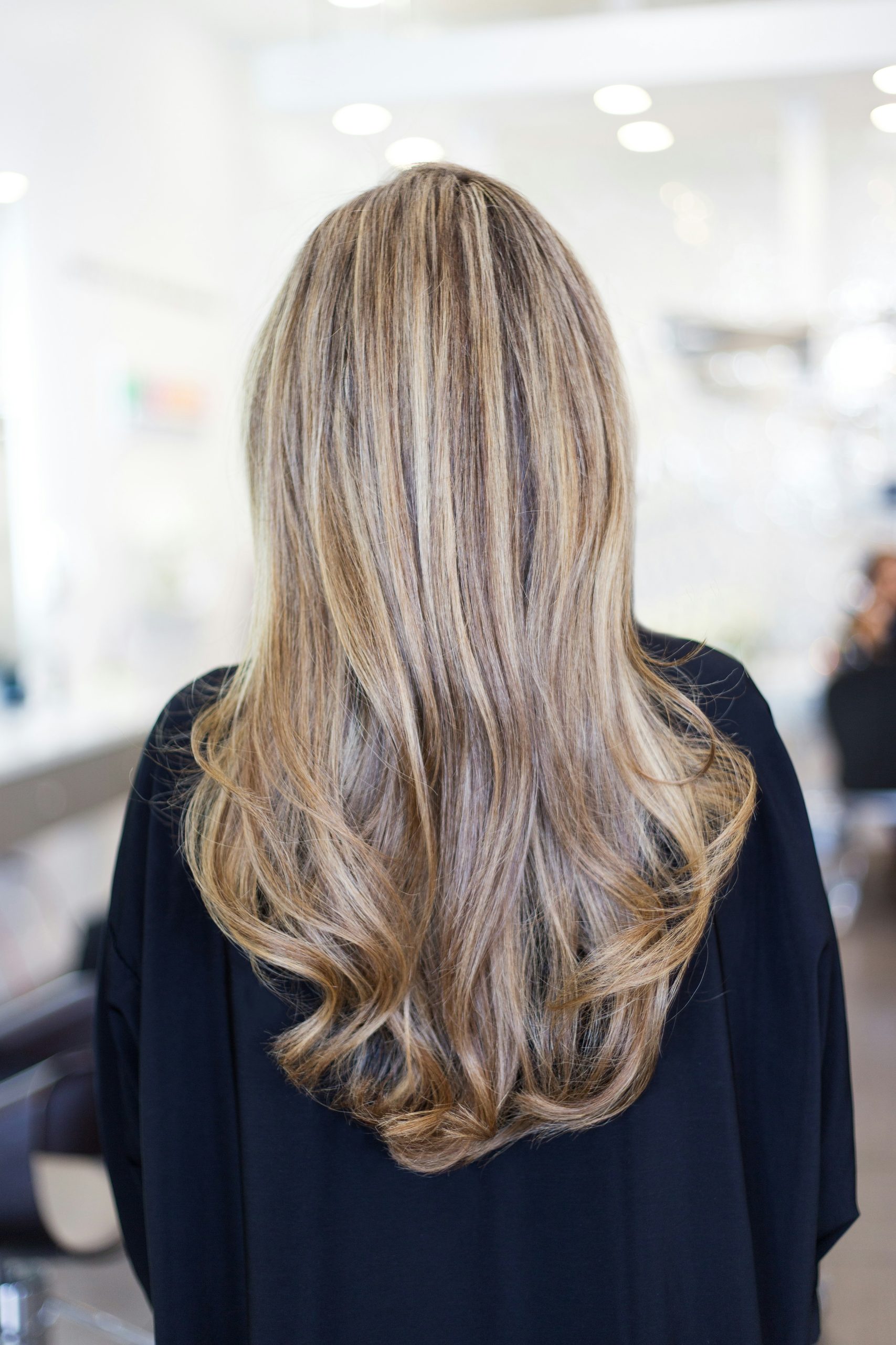 Shullet Haircut with Layered Fringe and Longer Textured Nape on Wavy Brown Hair