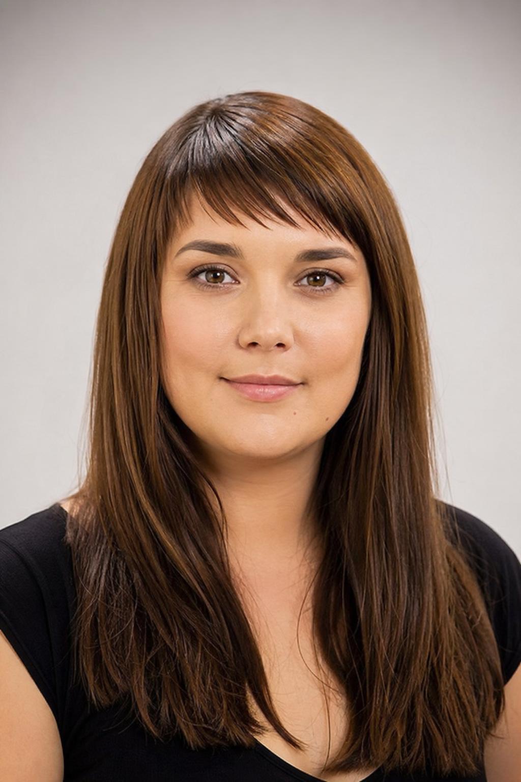 Slanted Baby Bangs on a Round Face with Long Smooth Brunette Hair
