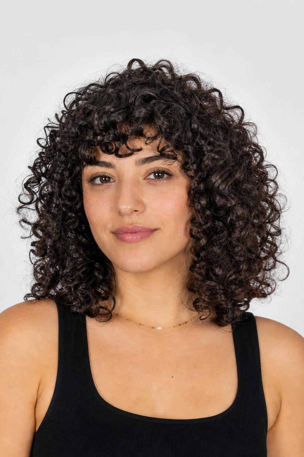 Curly Asymmetrical Fringe with Shorter Spirals on One Side on Dark Curls