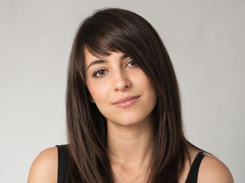 Asymmetrical Bangs Cut on a Diagonal Slant Across the Forehead on Dark Brown Hair