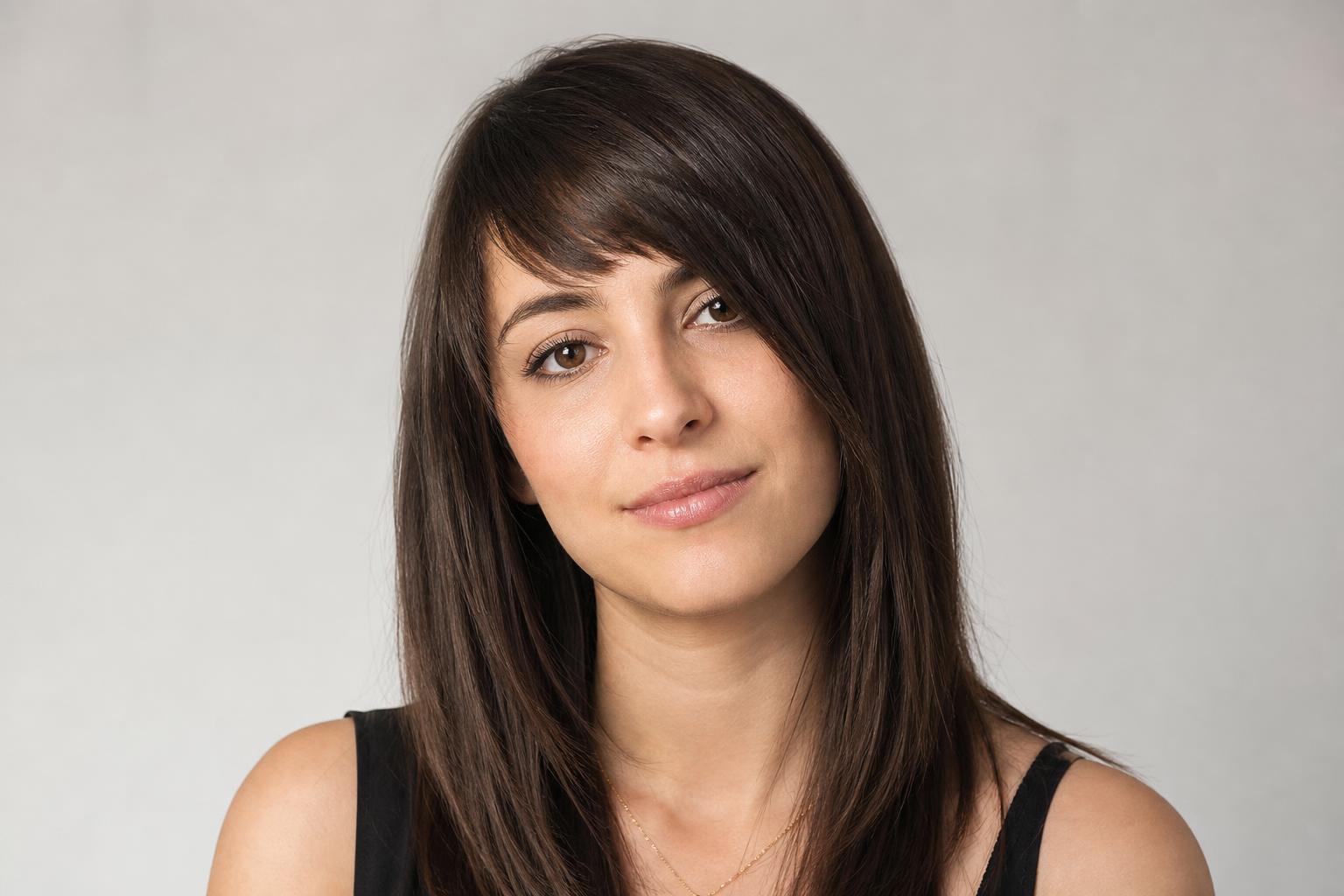 Asymmetrical Bangs Cut on a Diagonal Slant Across the Forehead on Dark Brown Hair