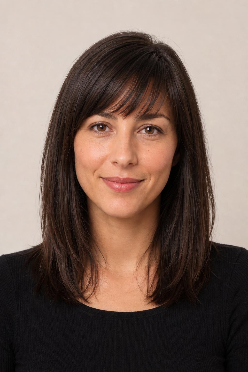 Wispy Brunette Bangs with a Subtle Half-Inch Slant on Medium Hair