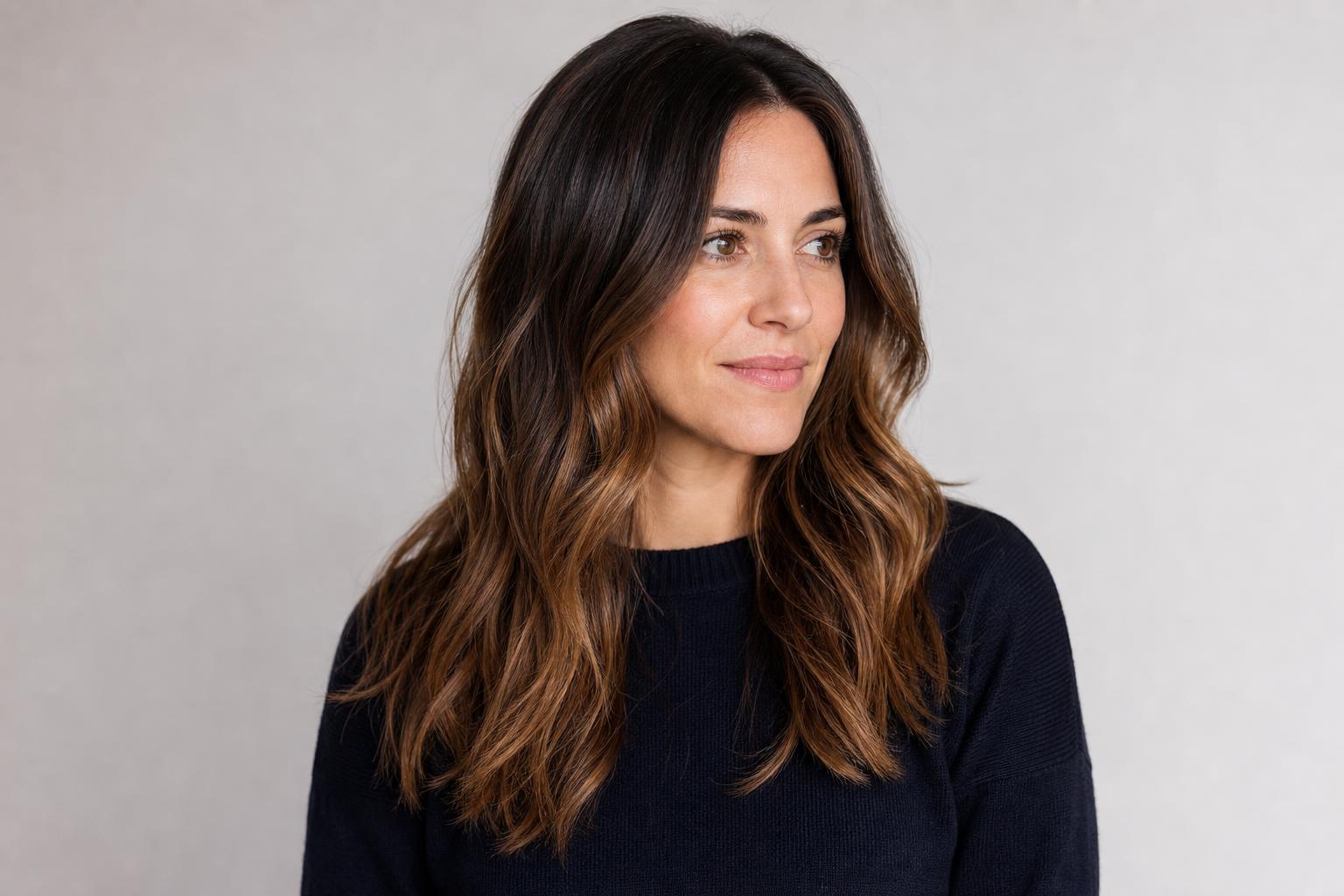 Lived-In Balayage Brightening the Mid-Lengths and Ends of Dark-Brown Wavy Hair
