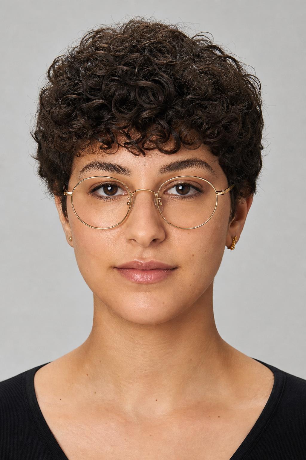 Cropped Curly Fringe Above Round Wire Glasses on Dark Coily Hair