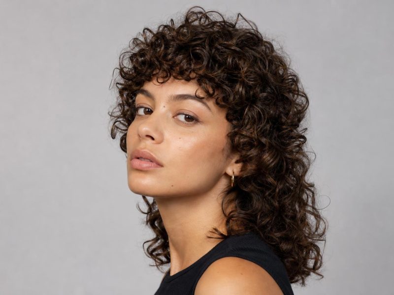 Curly Mullet with Short Crown Layers and Longer Curls at the Nape