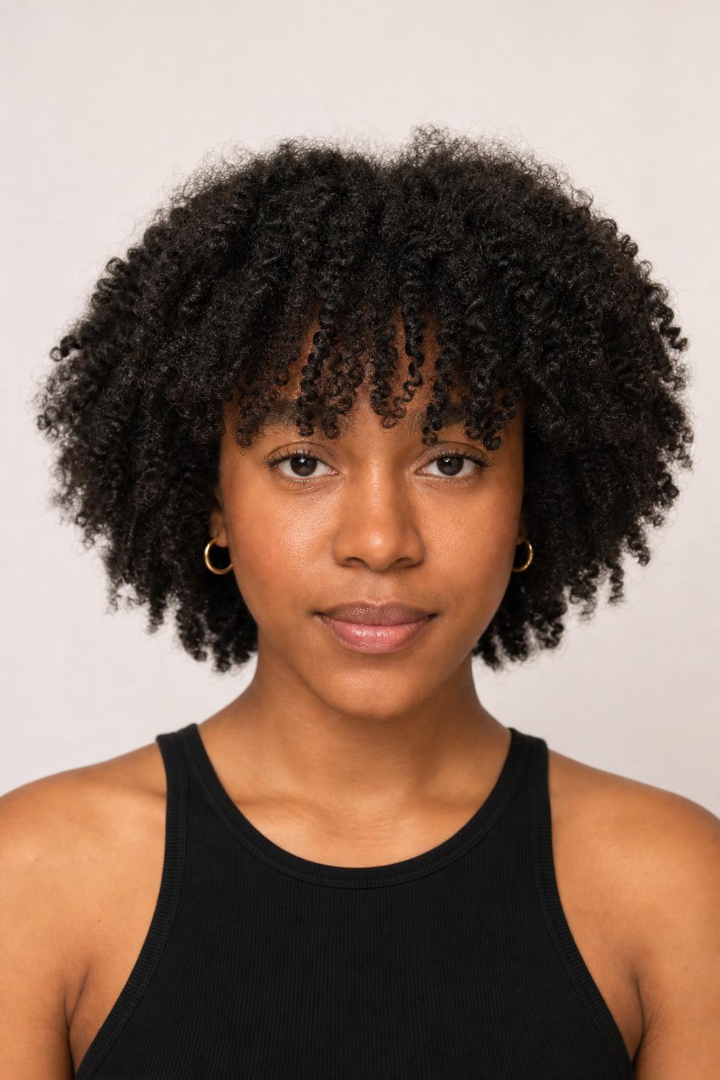 Coily French Fringe of Soft Defined Coils Framing the Brows on Black Hair