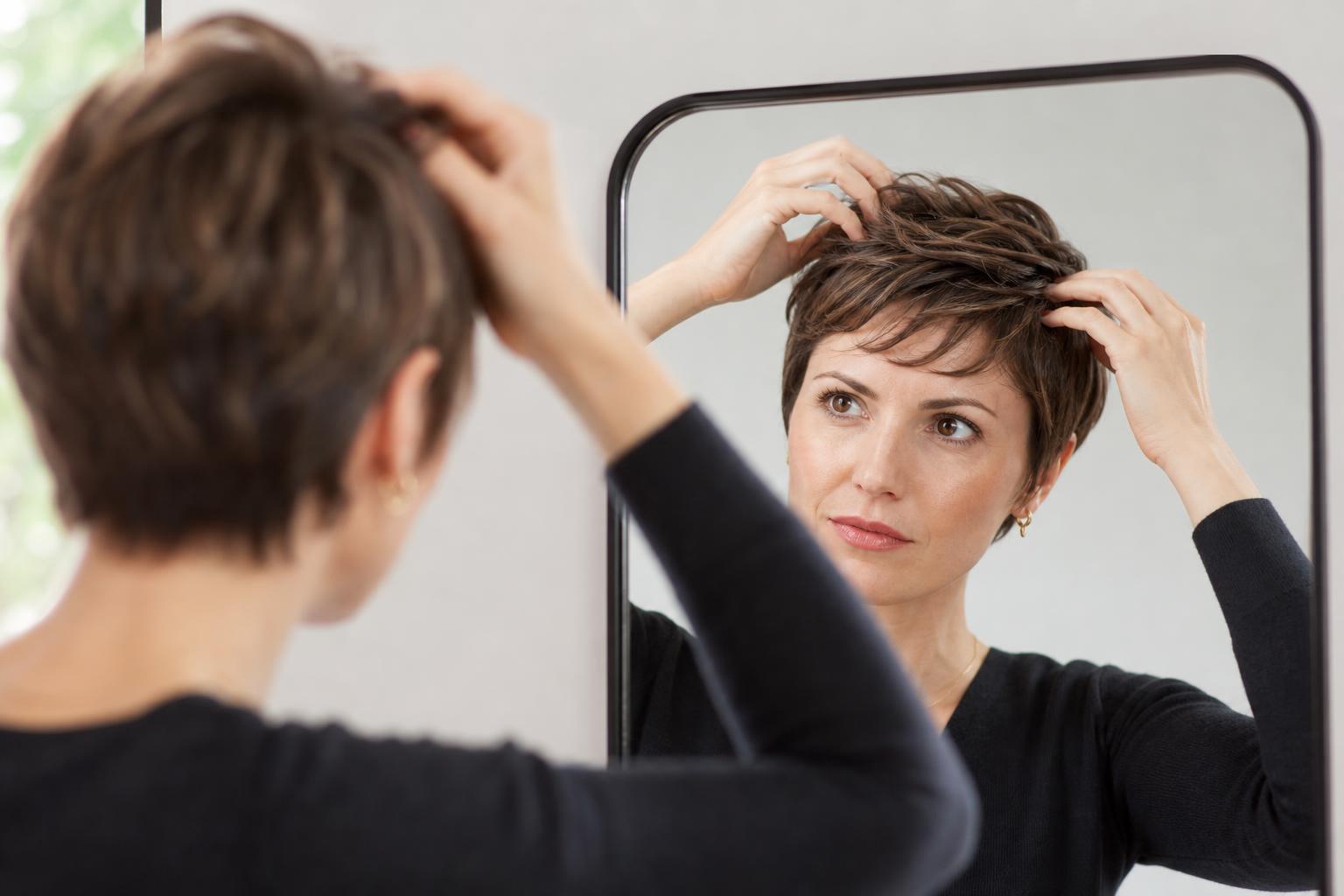 Applying Styling Paste with Fingertips to Style a Short Pixie Cut