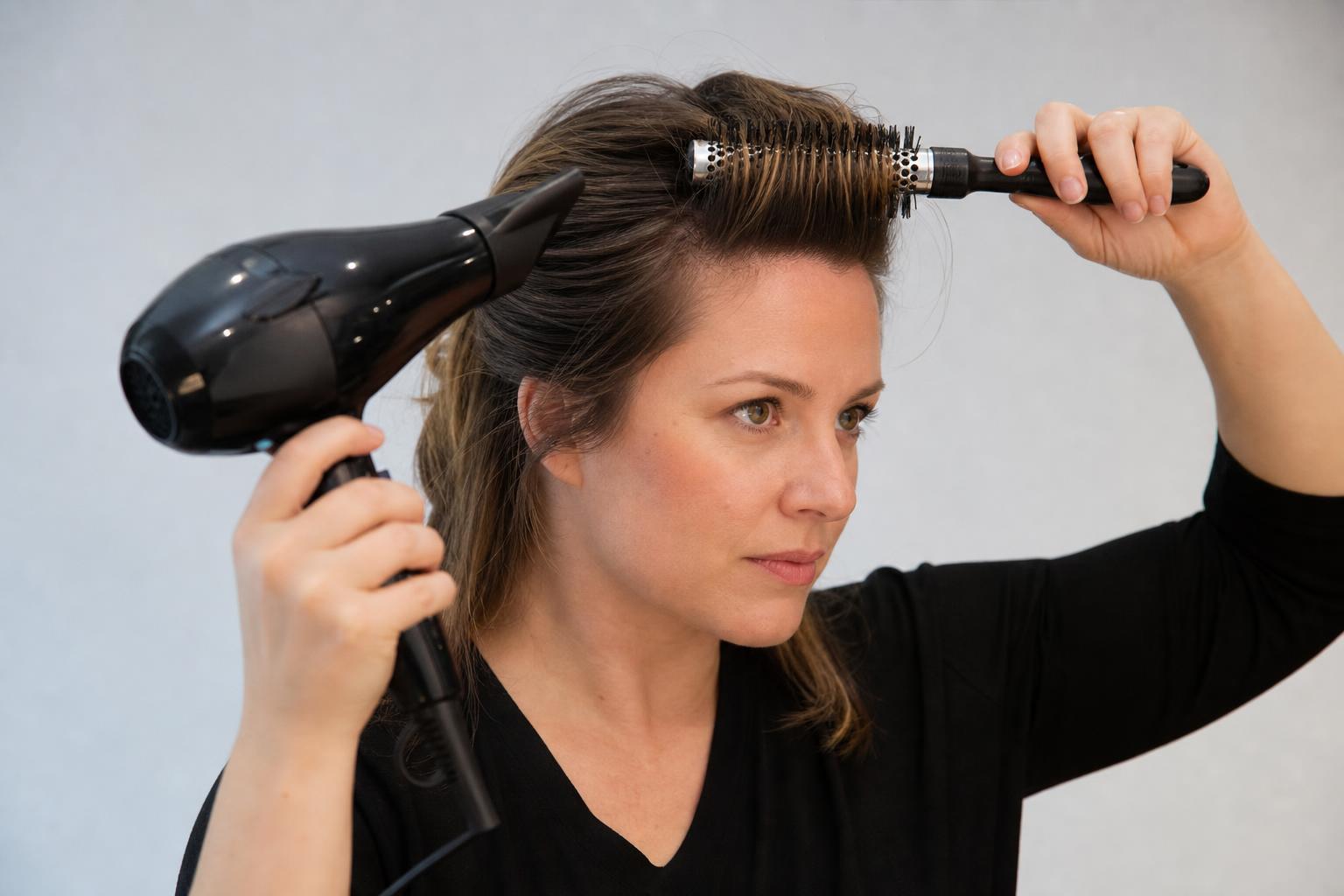 Blow-Drying Freshly Washed Bangs Upward with a Small Round Brush to Lift the Roots