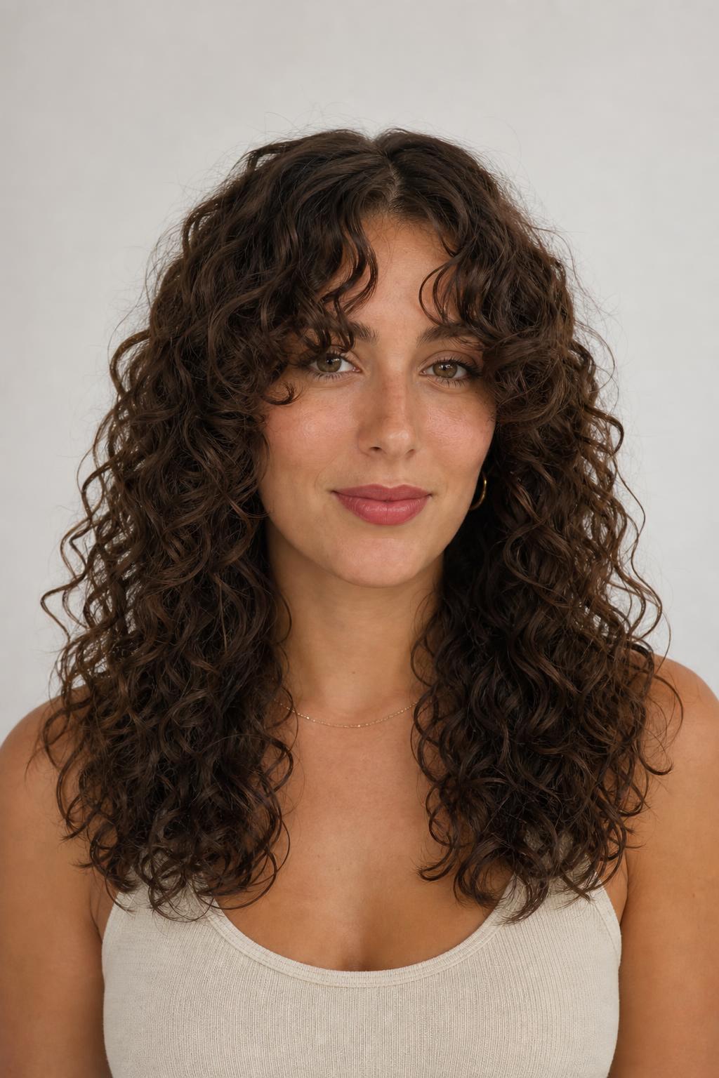 Curly Curtain Bangs Sweeping Out Toward the Cheekbones