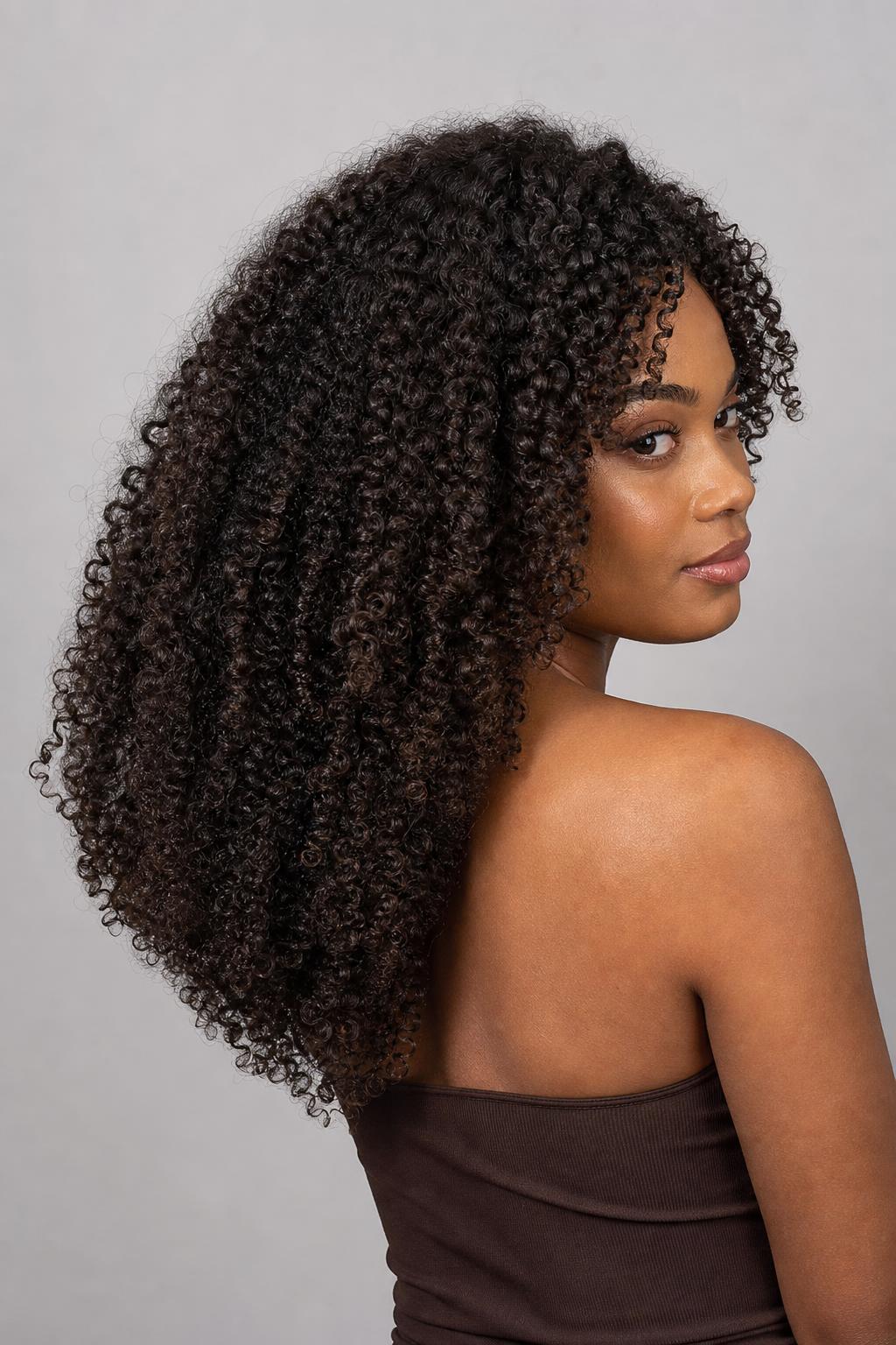 V-Shaped Curly Cut Tapering to a Defined Point at the Back