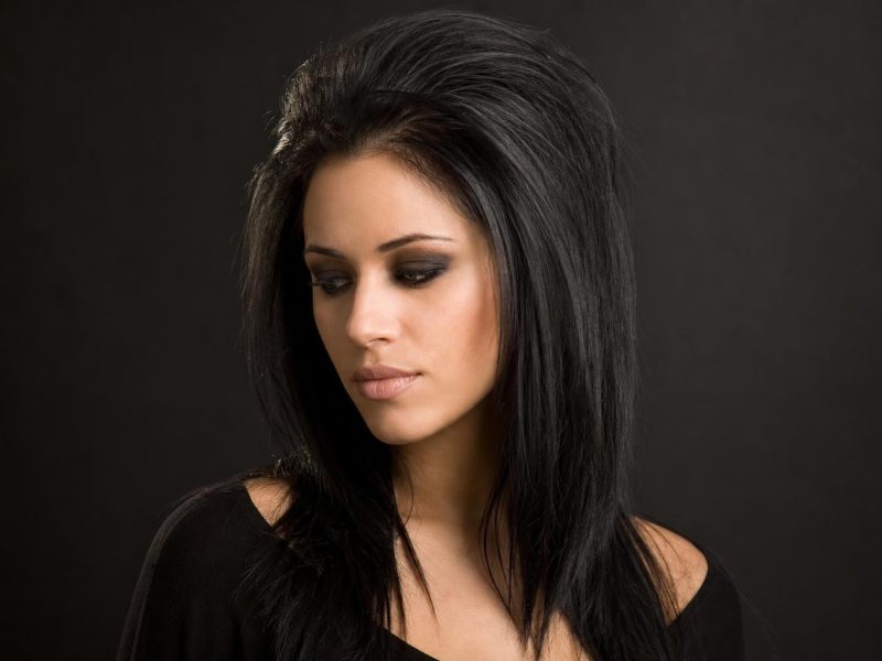 Dark Goth-Inspired Hairstyle with Teased Crown Volume and Deep Black Color on Thick Straight Hair