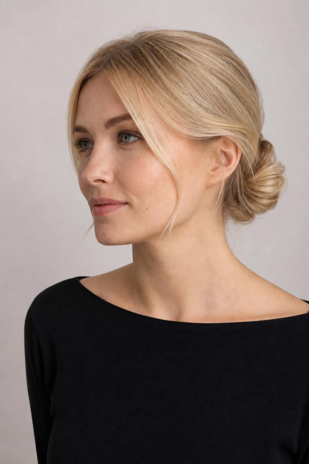 Neat Low Bun on Pale Blonde Hair with a Smooth Even Tone