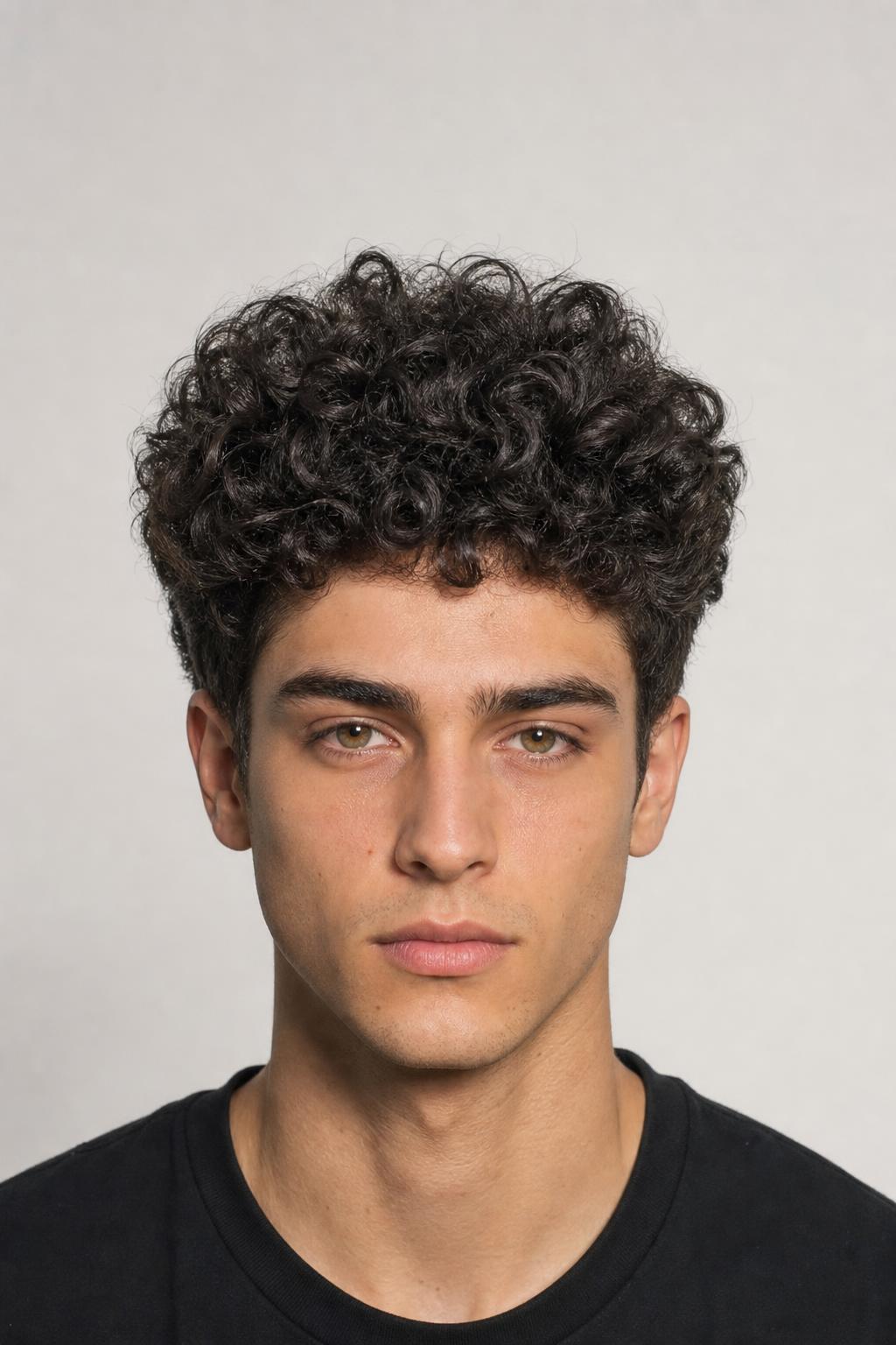 Blown-Out Coarse Curls Brushed Upward over a Tapered Side on Dark Hair
