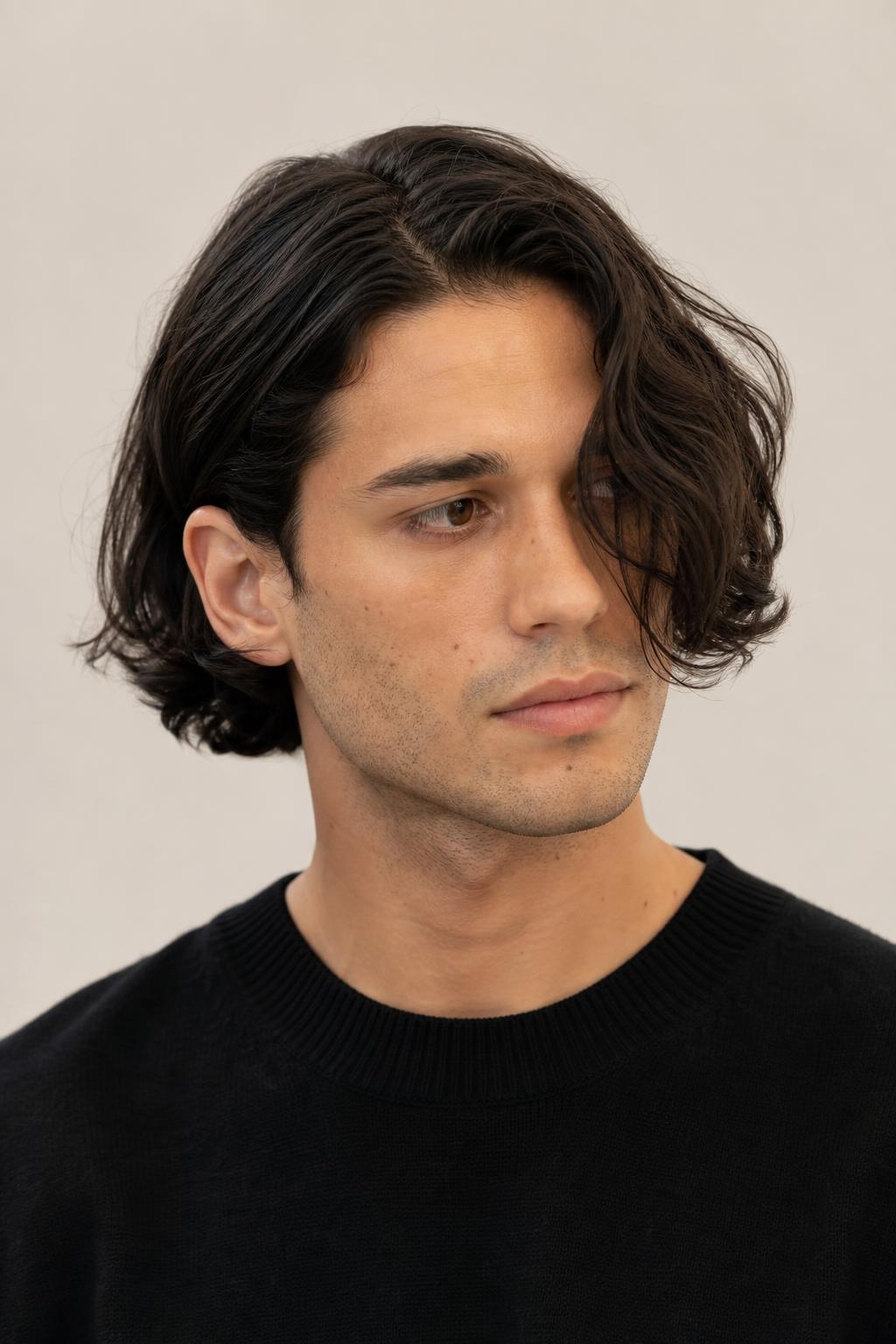 Long Center Part with One Side Tucked Behind the Ear on Dark Wavy Hair