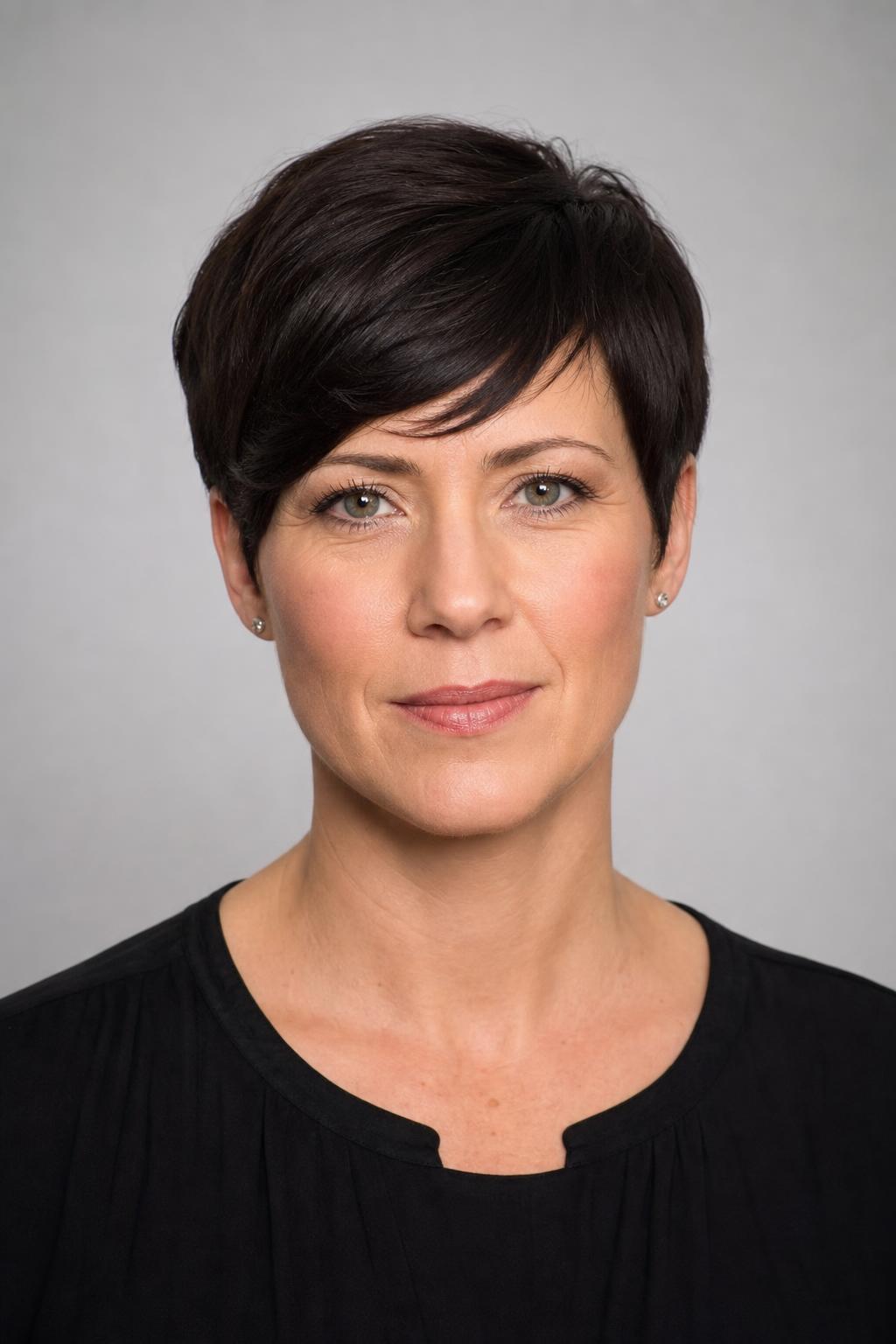 Side-Swept Pixie Kept Full Around the Ears With a Diagonal Fringe