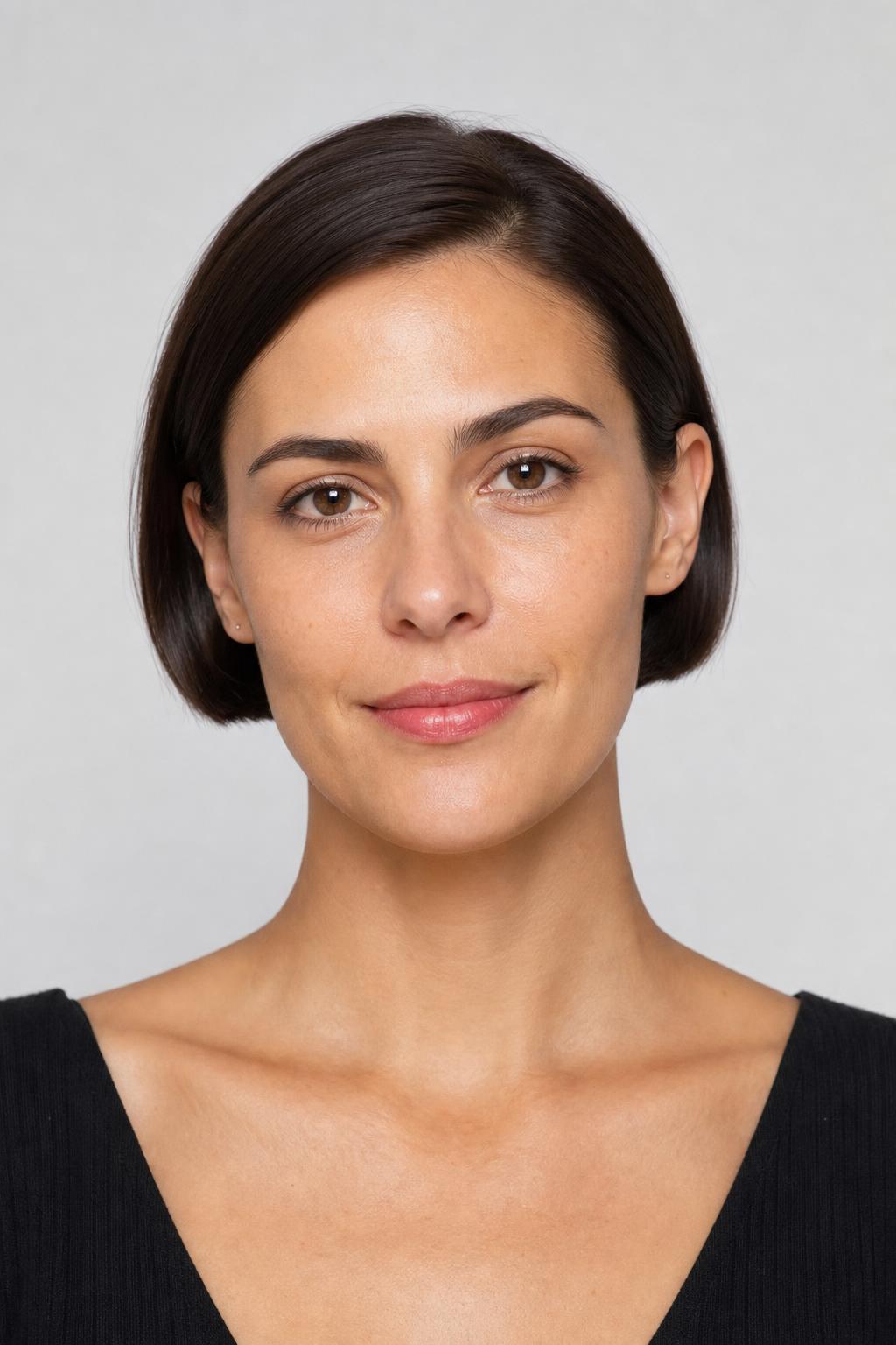 Earlobe-Length Micro Bob Tucked Behind Both Ears on Sleek Dark Hair